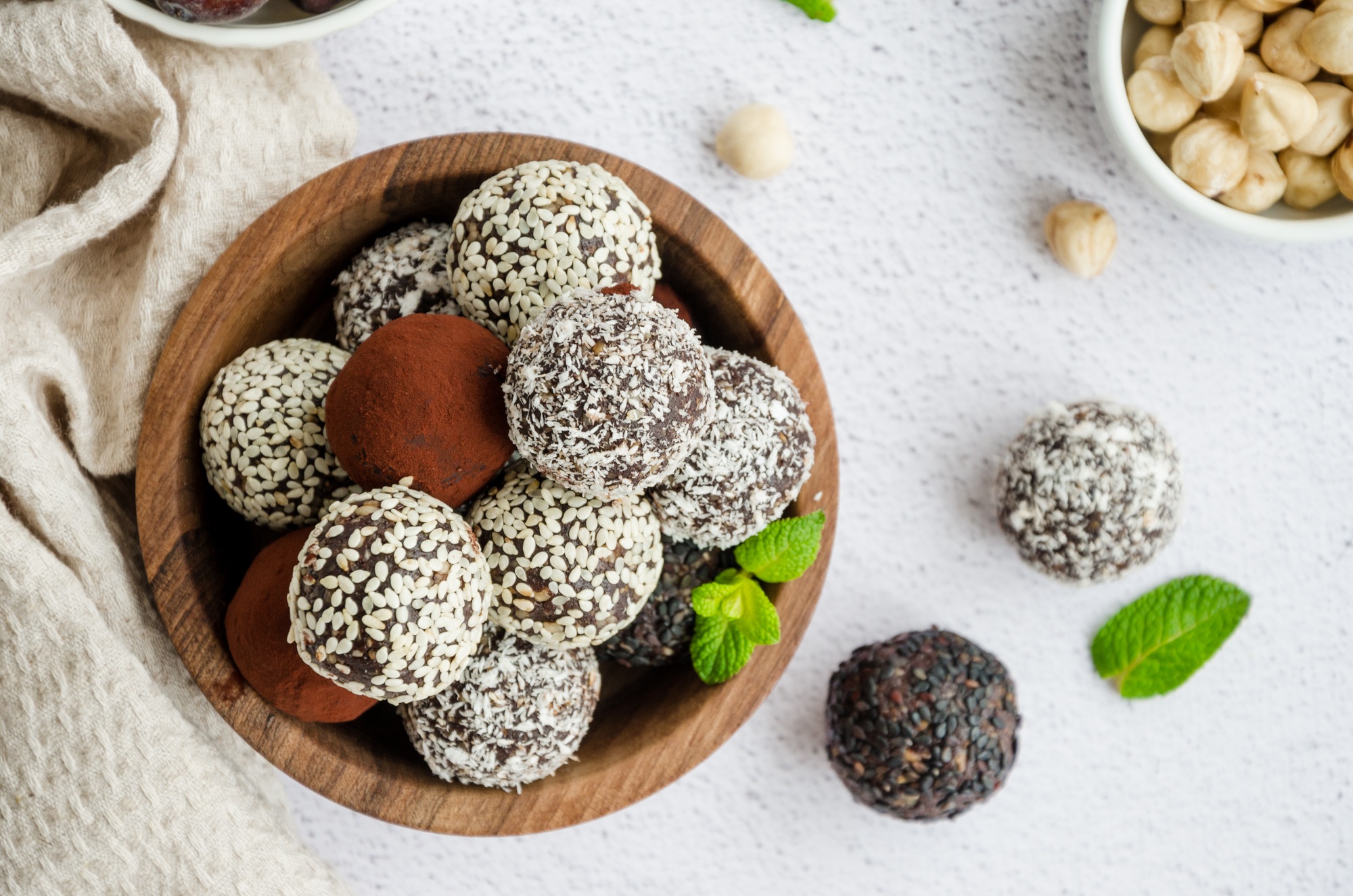 Energy balls. Truffles of dates, walnuts, hazelnuts and cocoa in a wooden bowl. Healthy dessert