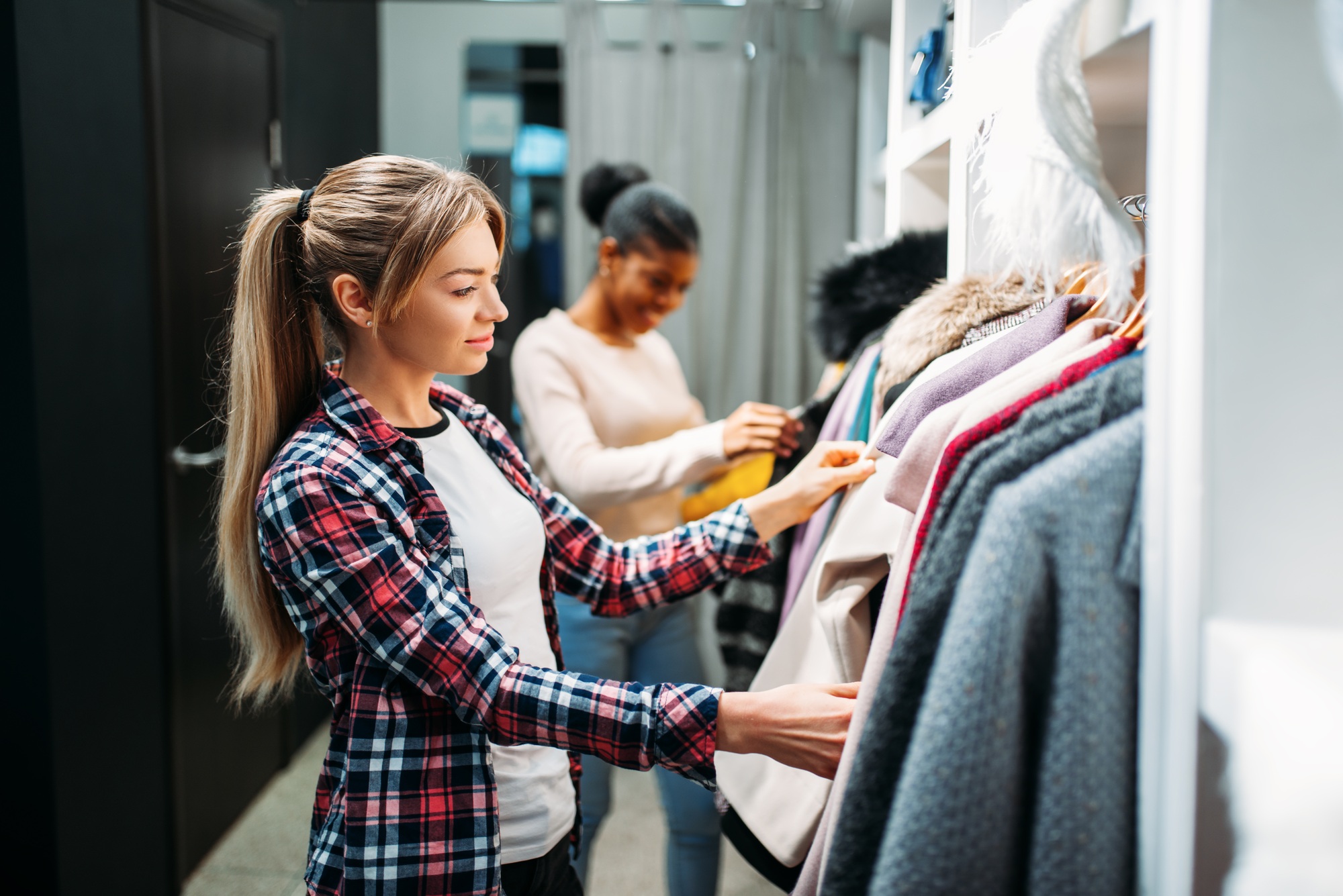 Two girlfriends choosing clothes, shopping