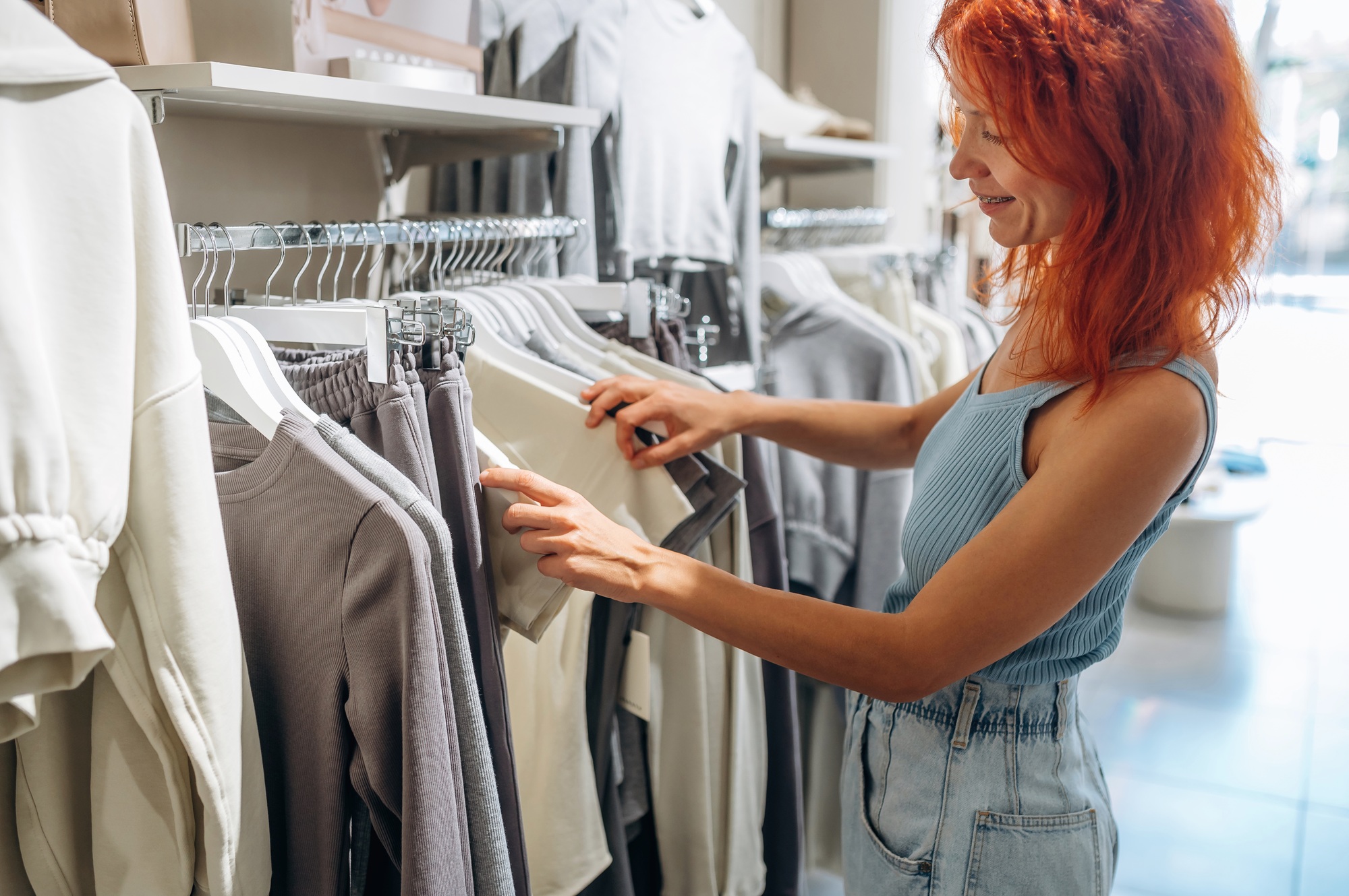 Chooses clothes. Woman is in retail store